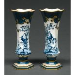 A pair of Royal Worcester flared hexagonal powder blue ground vases, 1912, printed and painted with