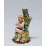 A Royal Worcester figural spill holder, 1889,Â  modelled with a child piper on a tree stump,