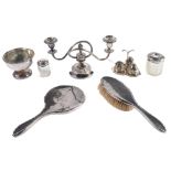 A George V silver hand mirror and hairbrush, silver capped cut glass hair tidy and glass jar with