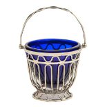 An Edwardian silver wirework sugar basket, with swing handle, blue glass liner, 68mm h excluding