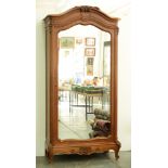 A French walnut armoire, late 19th / early 20th c, in Louis XV style, the mirror inset door