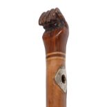 A malacca cane, Pitcairn Island, early 20th c, with carved hardwood clenched fist pommel, stamped in
