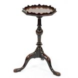 A George II mahogany kettle stand, the galleried octagonal top on inverted baluster pillar and