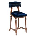 An Edwardian walnut chair,Â the padded blue velvet back rail with brass studs and deep fringe, the