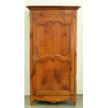 A Louis XVI cherrywood and inlaid armoire, the frieze decorated with vase of flowers, enclosed by