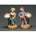 A pair of Royal Worcester boy and girl figures with baskets, c1875, brightly decorated in