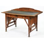 An art nouveau oak desk, French or Belgian, c1905, the low upstand to the gilt tooled leather