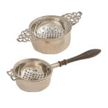 Two Elizabeth II silver tea strainers and stands, one with turned pearwood handle, 12.5 and 163.