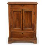 A French walnut cupboard, late 19th c, enclosed by a pair of panelled doors with drawer above and