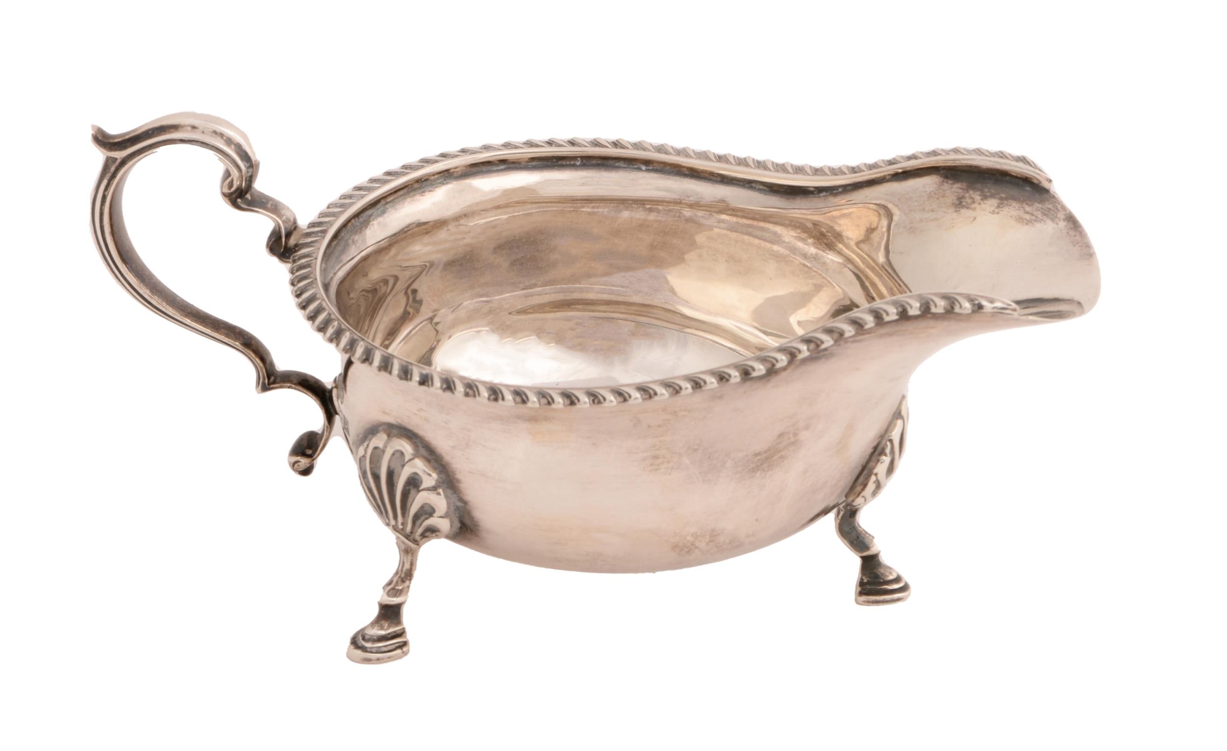 An Elizabeth II silver sauceboat, with gadrooned rim, on three hoof feet, 16.5cm l, by Elkington &