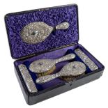 A Victorian silver six piece brush set, stamped with birds and chrysanthemums, by Arthur