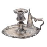 A William IV silver chamberstick, the rim chased with shells and C scrolls, nozzle and snuffer,