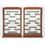 A pair of South East Asian wall hanging hardwood cabinets for the display of snuff bottles or