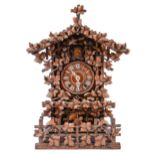 A Swiss walnut cuckoo clock, late 19th c, in the form of a chalet embowered with fruiting vines