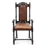 A carved and dark-stained oak armchair, early 20th c, in Charles I style, with added splat and seat,