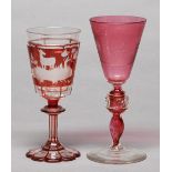 A Bohemian ruby flashed and wheel engraved glass goblet, c1850, on scalloped star cut foot and