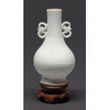 A South East Asian celadon vase, Qing dynasty, with 'S' scroll handles, 11.5cm h, wood stand Neck