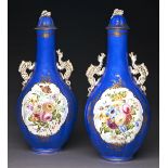 A pair of Staffordshire dragon handled bone china bottle shaped vases and covers, c1850, painted