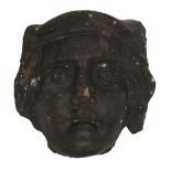 A carved sandstone face of a Saint, 19th / early 20th c, in medieval style, 15cm h Chipped; black