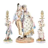 A French biscuit group of lovers  arm in arm, on a rocky base and painted in pastel hues, with