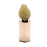 A miniature jade carving of a monkey on affixed tubular silver stand, 20th c, 22mm h overall Good