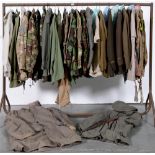 Military uniform.  Miscellaneous army tunics, shirts, trousers and other garments,    used by the