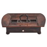 An early Victorian rosewood inkstand, with sloping sides and curved ends centred by a bronze