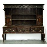 An oak dresser, 19th c, the associated boarded rack with turned pendants and lunette frieze, spice