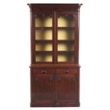 A Victorian mahogany bookcase, the upper part fitted with adjustable shelves enclosed by glazed