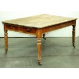 A Victorian pine kitchen table, fitted with a drawer on turned legs, retaining traces of the