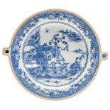 A Chinese export blue and white water plate, c1800, painted with a landscape in diaper border, the