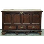 A George III oak mule chest, with substantial, moulded lid, the front having four ogee raised and