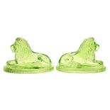 A pair of John Derbyshire press moulded green glass 'Landseer lions' paperweights, 1874-1900, on