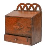 A George III wall hanging oak candle box with drawer, with pierced arcaded gallery and sloping lid