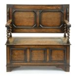 An oak monks bench, c1930, with panelled front, 78cm h (top down); 50 x 106cm Good condition
