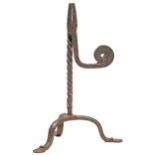 An English iron rush nip, 18th c, the spiral stem on tripod, 25cm h Rusty