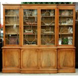 A mahogany breakfront bookcase, 20th c, with dentil cornice, crossbanded and line inlaid throughout,