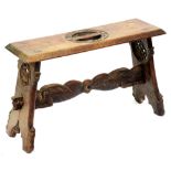 A Victorian medievalist trestle stool, carved and pierced to the top with a central ring of