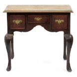 A George II oak lowboy, with line inlaid top, three moulded drawers to the arched apron, on shell