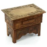 A Chinese carved wood collapsible table, early 20th c, the top and all sides decorated with