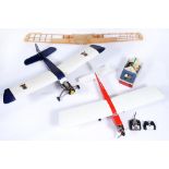Two painted balsa wood model aircraft, with Enya or other engine and related remote control