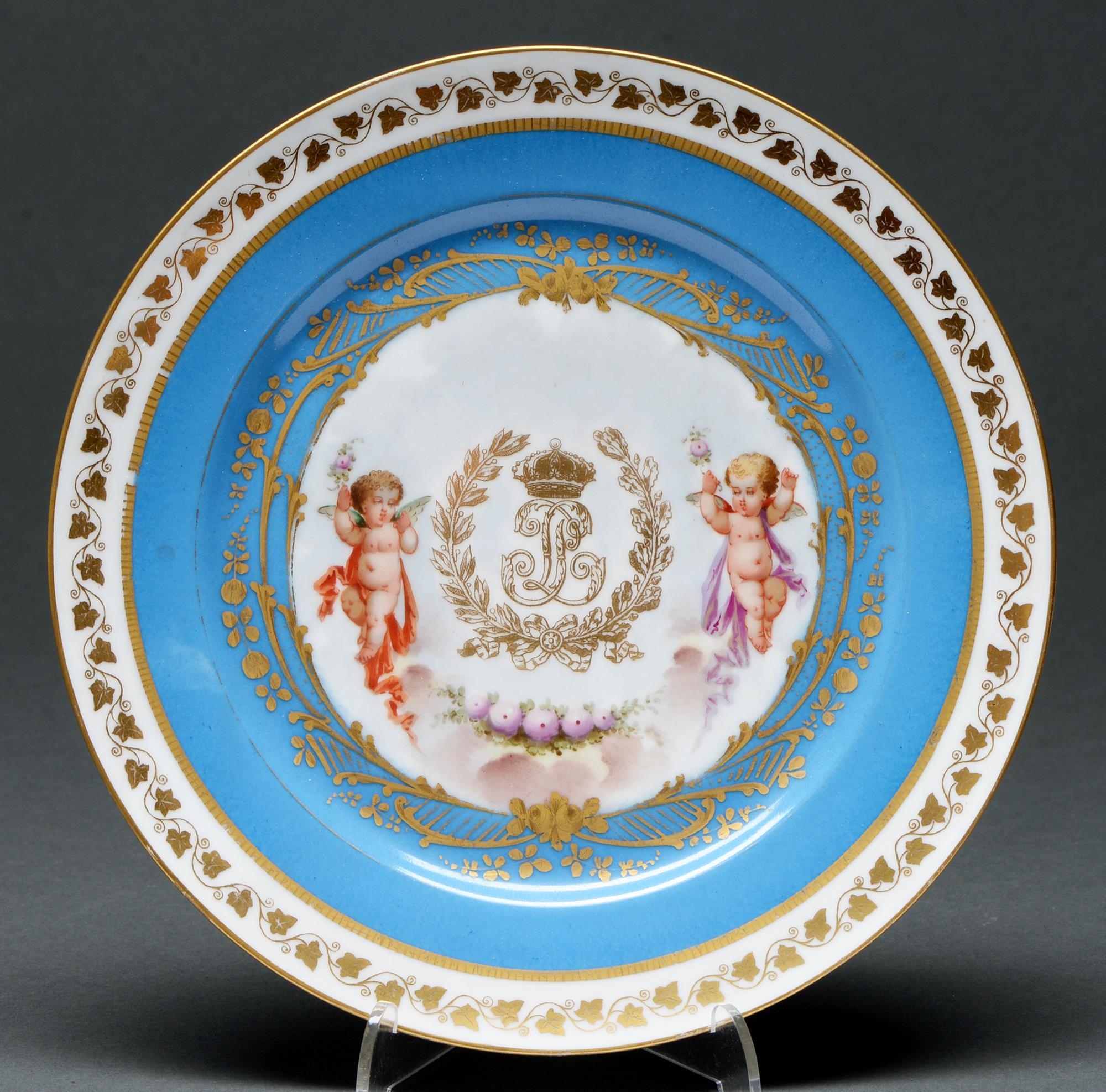 A Sevres style bleu celeste ground plate, late 19th c, the centre gilt with the cipher of Louis