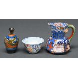 A Chinese Imari tea bowl, second half 18th c, 65mm diam, a miniature Gouda Art Pottery vase and a