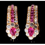 A pair of ruby and diamond ear clips, with heart shaped cluster and line and calibre cut rubies,