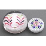 A Clichy muslin ground garland paperweight, 19th c, 60mm diam and another, larger  glass paperweight