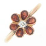 A diamond and garnet flower cluster ring, in gold marked 9ct, 2.8g, size Q Diamond of irregular