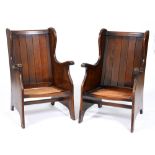 A pair of oak wing back 'cottage' easy armchairs, mid 20th c, 96cm h Note: sold without cushions