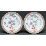 A pair of Chinese famille rose plates, 19th / early 20th c, enamelled with a fruiting peach tree