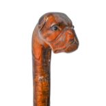 A carved wood cane, early 20th c, the pommel carved as the head of a boxer dog with glass bead eyes,