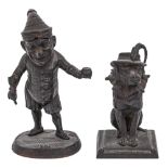 Two German miniature cast iron figural match stands in the form of Mr Punch and the dog Toby, E G